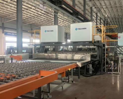 Techwin TWQX-3300G-3 jumbo horizontal glass washing machine running in a production line