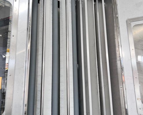 Three pairs of brushes with rollers between them on the Techwin vertical glass washing machine